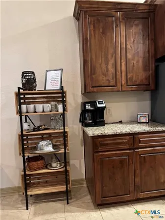 a kitchen with wooden cabinets and a stove top oven
