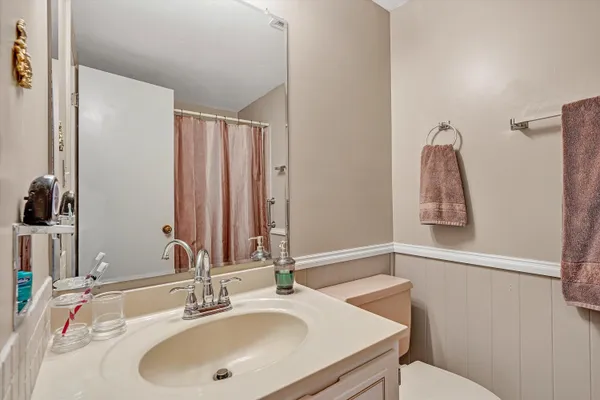 a bedroom with a bed dresser and a flat tv screen