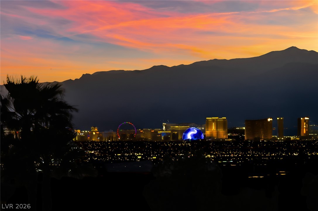 1104 Norellat Road Henderson, NV 89011 - Photo 47 of 52 Gaze across the sparkling city lights toward dramatic mountain silhouettes framed by sunset skies.