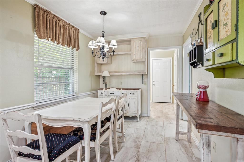 13429 Spring Grove Avenue Dallas, TX 75240 - Photo 11 of 25 a view of a dining room with furniture window and wooden floor