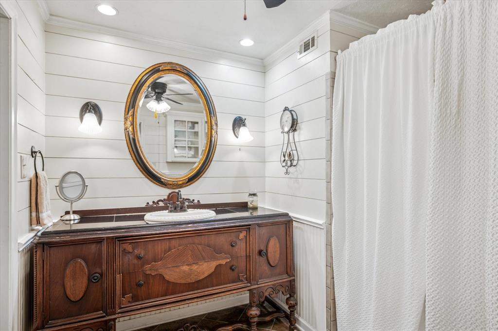 13429 Spring Grove Avenue Dallas, TX 75240 - Photo 14 of 25 a bathroom with a sink and a mirror