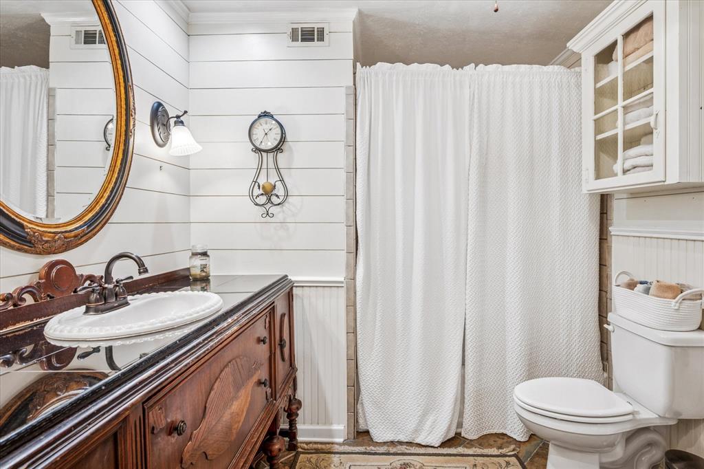 13429 Spring Grove Avenue Dallas, TX 75240 - Photo 15 of 25 a bathroom with a granite countertop sink and a mirror