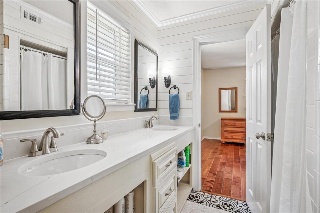 13429 Spring Grove Avenue Dallas, TX 75240 - Photo 19 of 25 a bathroom with a sink double vanity and a mirror