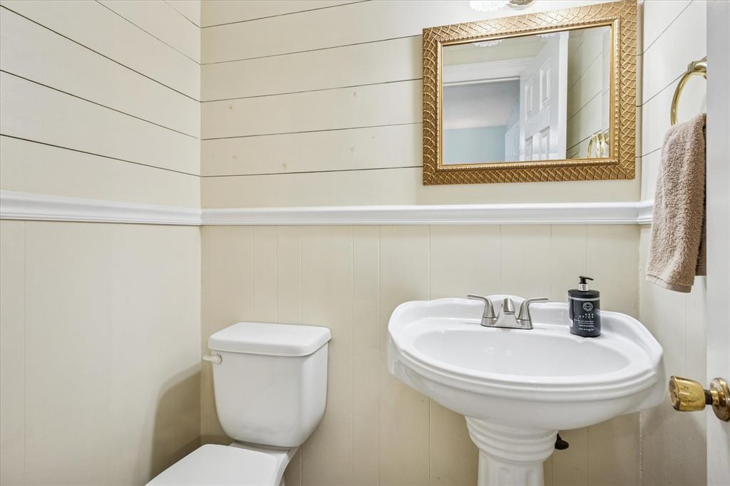 13429 Spring Grove Avenue Dallas, TX 75240 - Photo 20 of 25 a white toilet sitting next to a bathroom sink