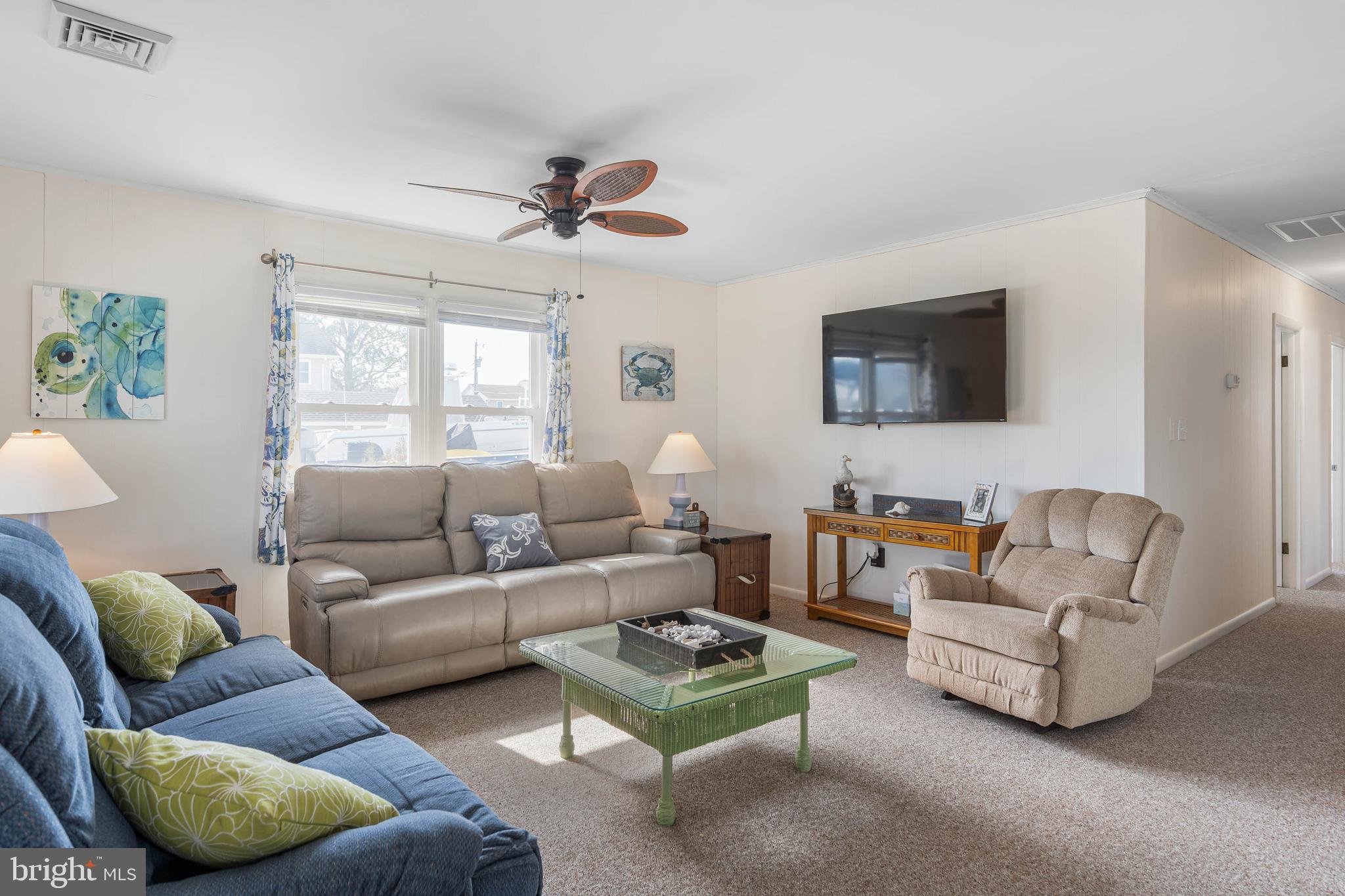 30200 Kent Road Dagsboro, DE 19939 - Photo 13 of 48 a living room with furniture a ceiling fan and a window