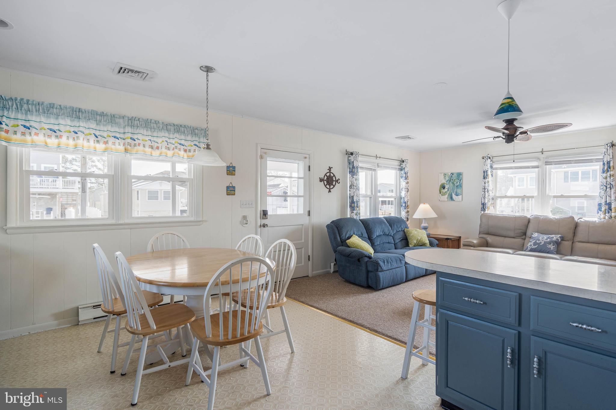 30200 Kent Road Dagsboro, DE 19939 - Photo 9 of 48 a view of a dining room and livingroom with furniture wooden floor a chandelier