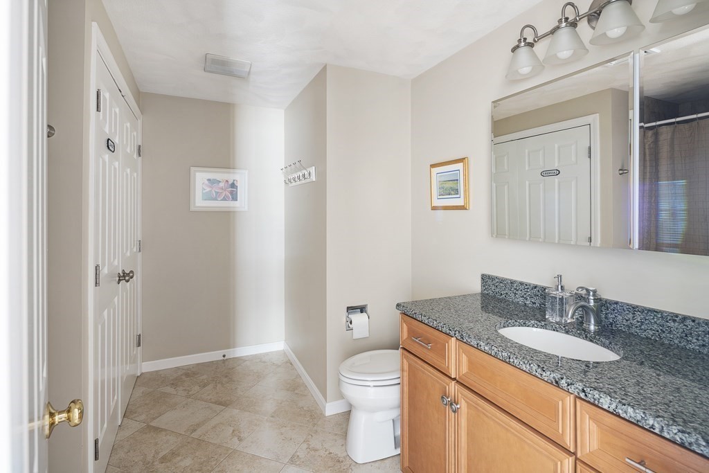102 4th Street, Unit 2 Medford, MA 02155 - Photo 12 of 17 a bathroom with a granite countertop sink toilet and shower