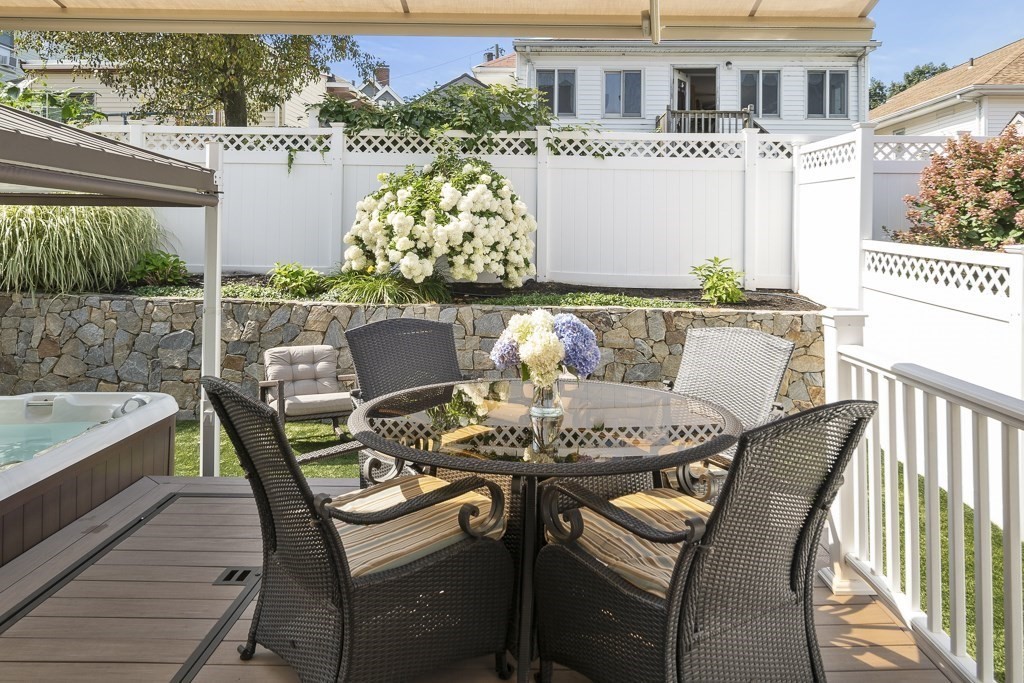 102 4th Street, Unit 2 Medford, MA 02155 - Photo 15 of 17 a front view of a house with a chairs and table