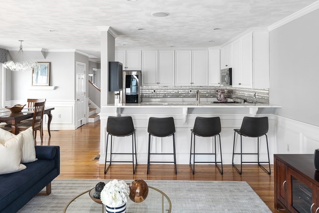 102 4th Street, Unit 2 Medford, MA 02155 - Photo 4 of 17 a kitchen with cabinets and chairs
