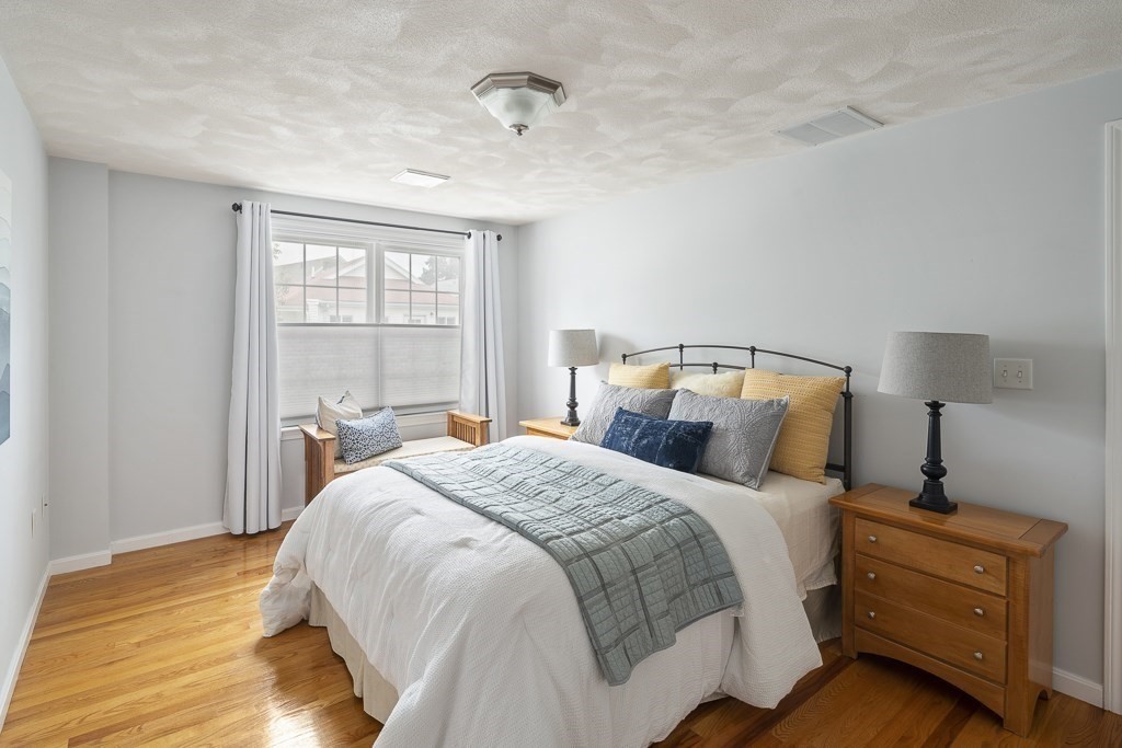 102 4th Street, Unit 2 Medford, MA 02155 - Photo 8 of 17 a bedroom with a bed and a window