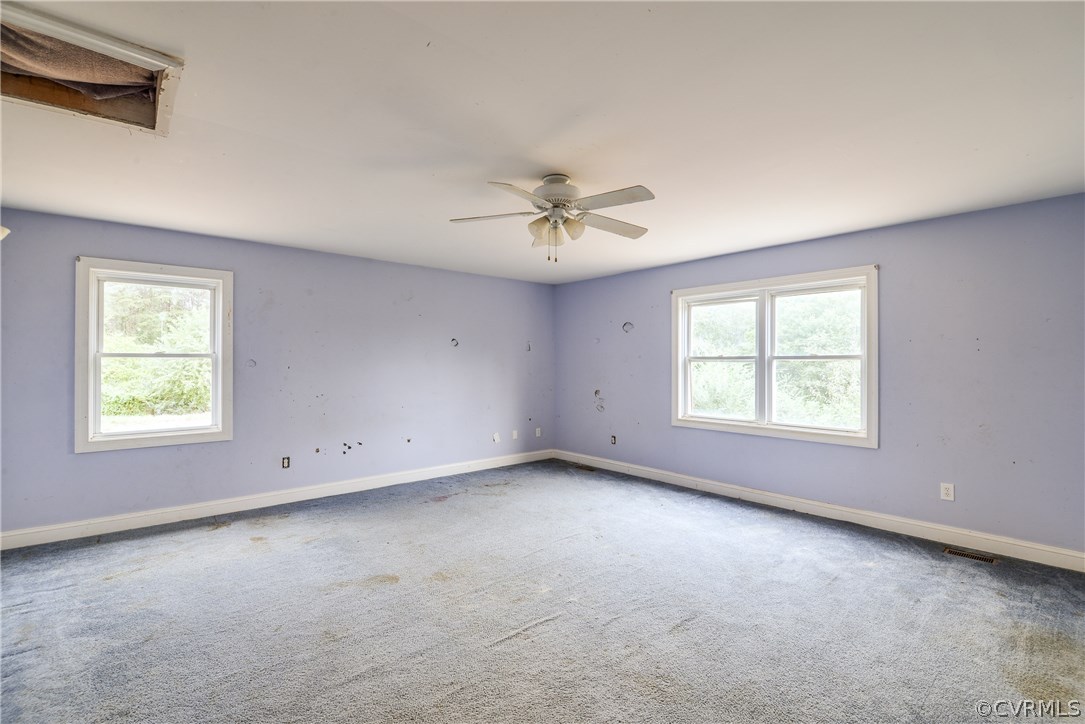 708 Buckner Road Bumpass, VA 23024 - Photo 17 of 40 an empty room with a window and a ceiling fan