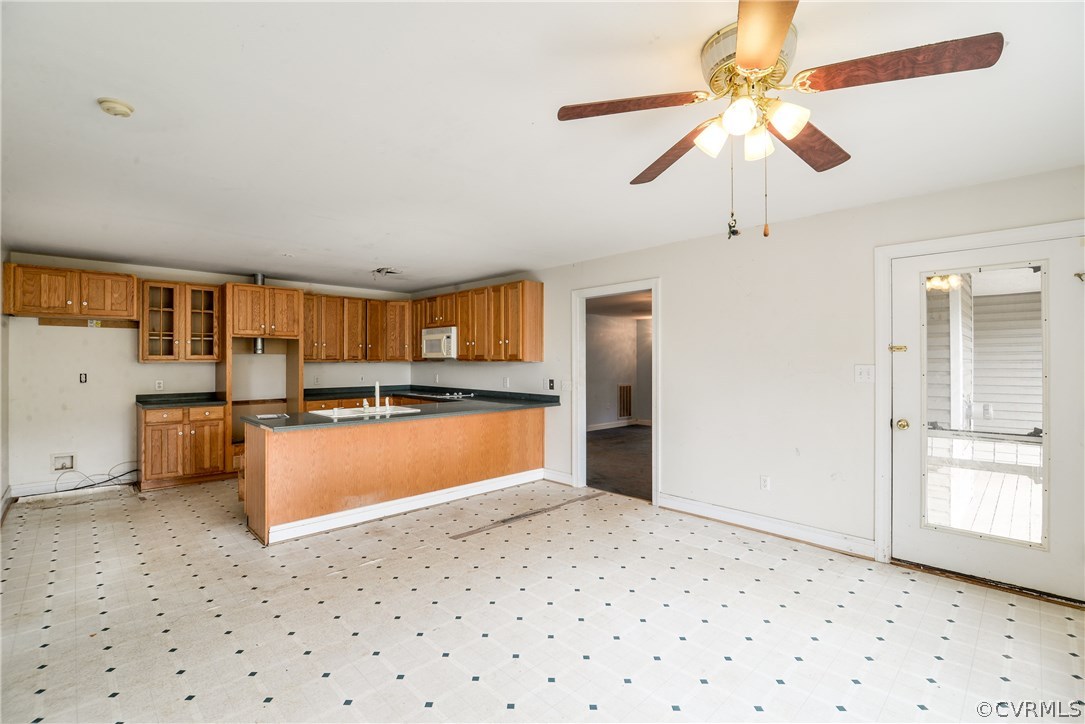 708 Buckner Road Bumpass, VA 23024 - Photo 20 of 40 a kitchen with stainless steel appliances kitchen island granite countertop a refrigerator and a sink
