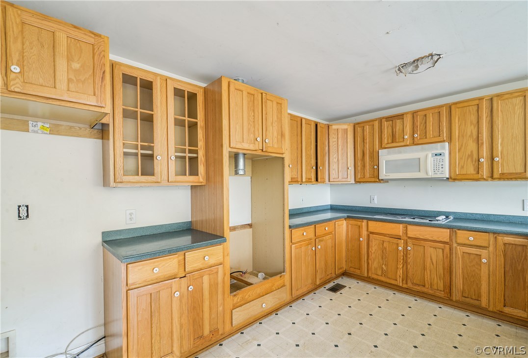 708 Buckner Road Bumpass, VA 23024 - Photo 21 of 40 a kitchen with stainless steel appliances a refrigerator sink and cabinets