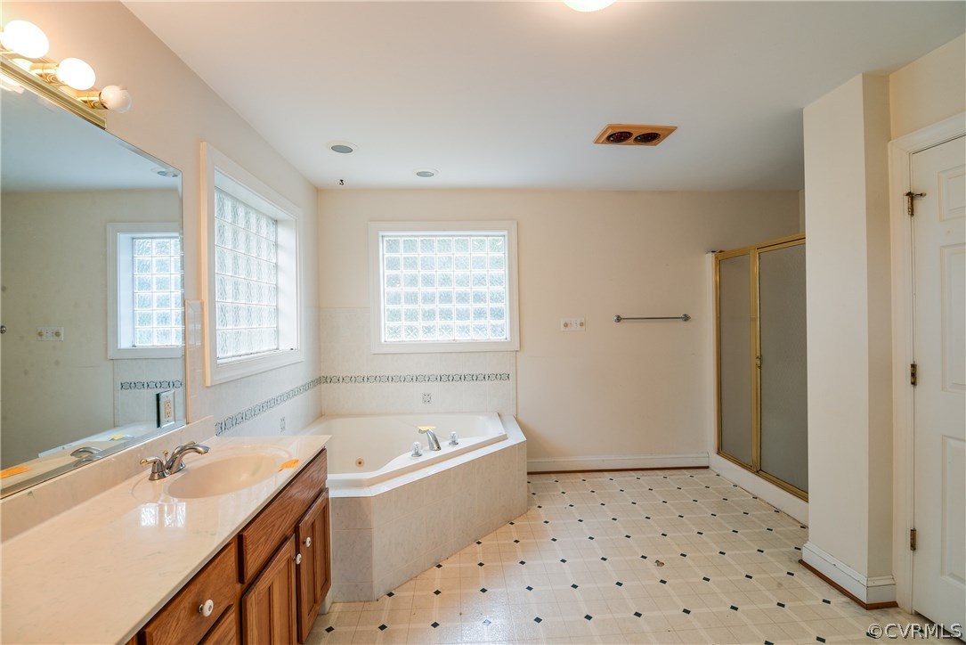 708 Buckner Road Bumpass, VA 23024 - Photo 27 of 40 a bathroom with a bathtub sink and mirror