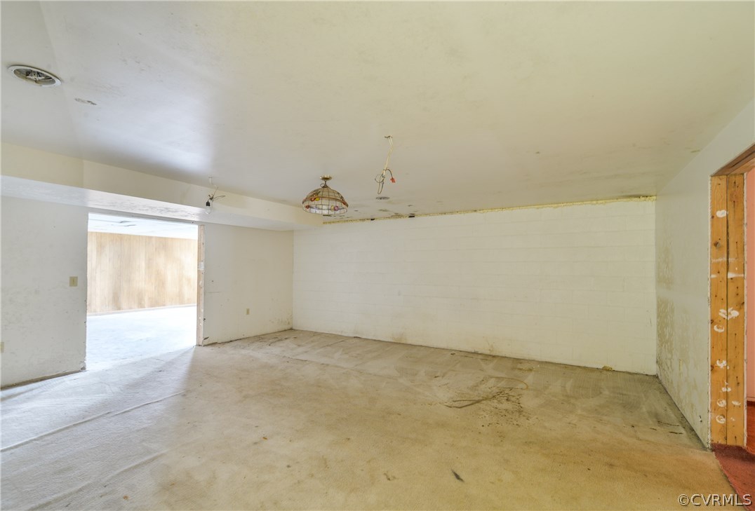 708 Buckner Road Bumpass, VA 23024 - Photo 10 of 40 an empty room with a natural light