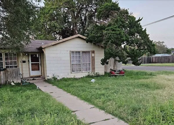 a front view of house with yard and trees