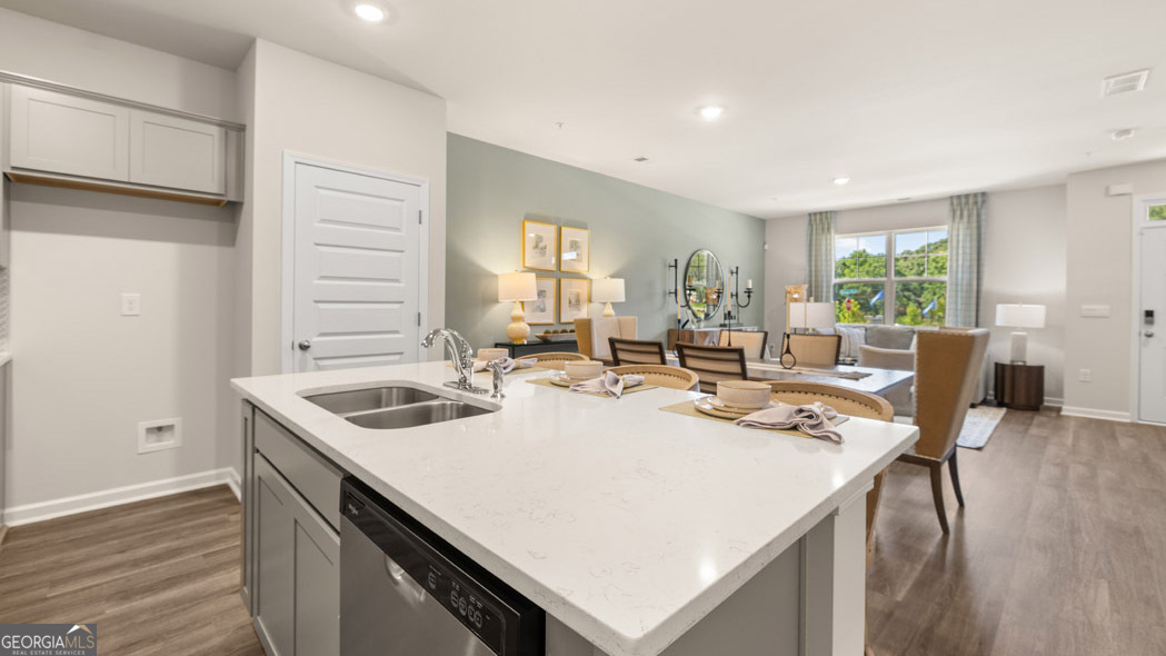 420 Reflection Drive Stockbridge, GA 30281 - Photo 18 of 58 a open kitchen with stainless steel appliances granite countertop a sink a stove and island with wooden floor