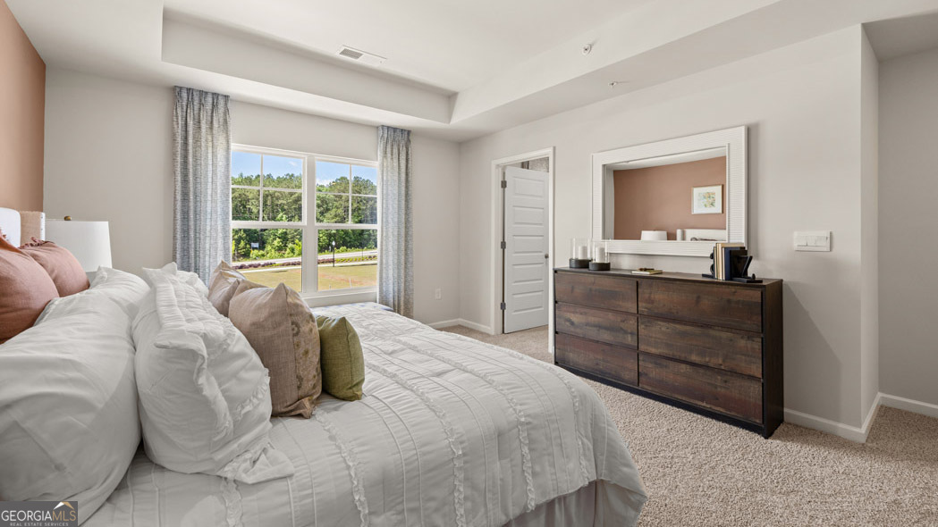 420 Reflection Drive Stockbridge, GA 30281 - Photo 35 of 58 a bedroom with a bed and a dresser