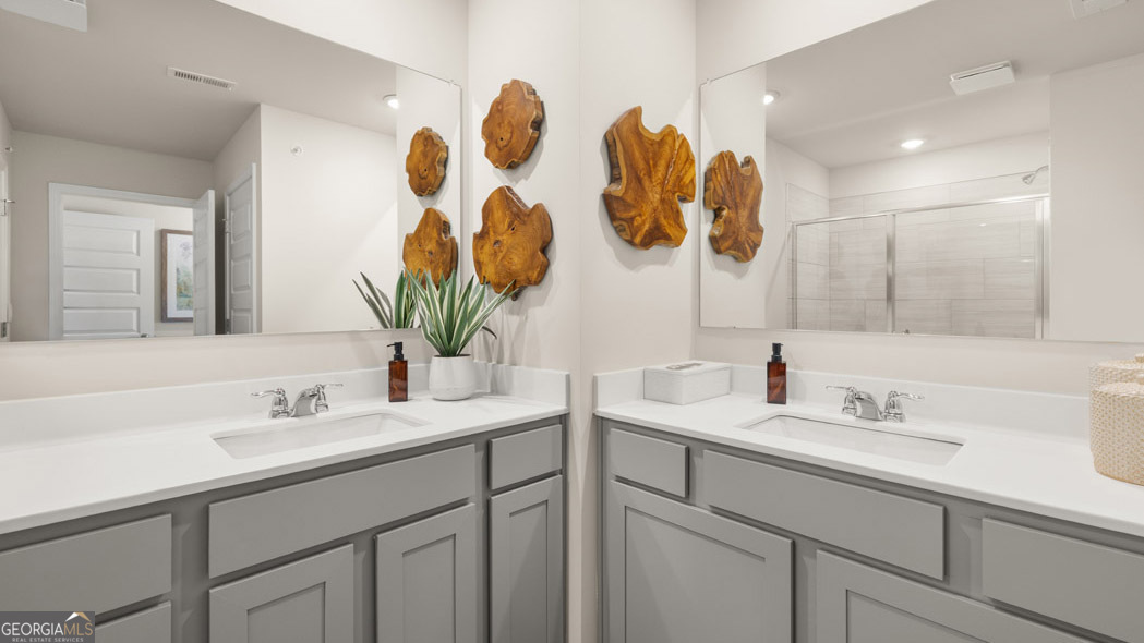 420 Reflection Drive Stockbridge, GA 30281 - Photo 39 of 58 a bathroom with a sink and a mirror