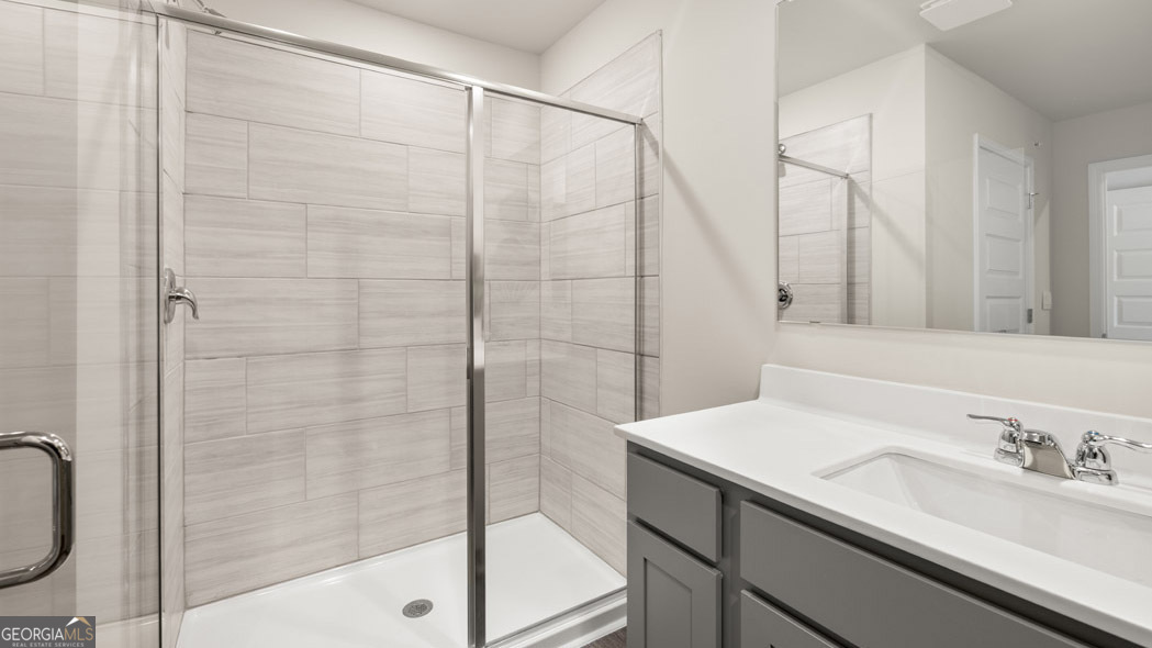 420 Reflection Drive Stockbridge, GA 30281 - Photo 41 of 58 a bathroom with a granite countertop sink a mirror and shower