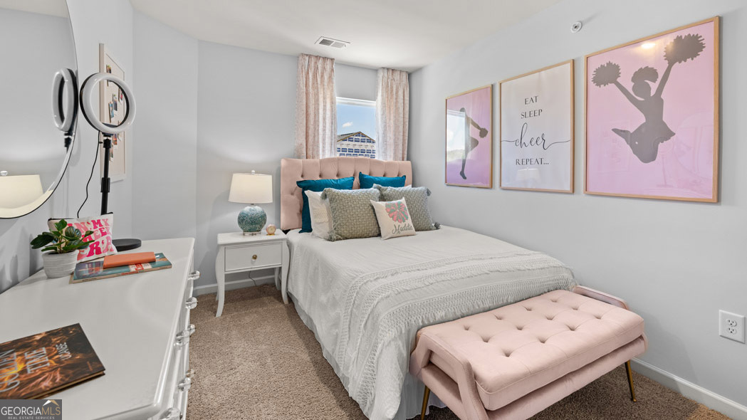 420 Reflection Drive Stockbridge, GA 30281 - Photo 53 of 58 a bedroom with a bed and wooden floor