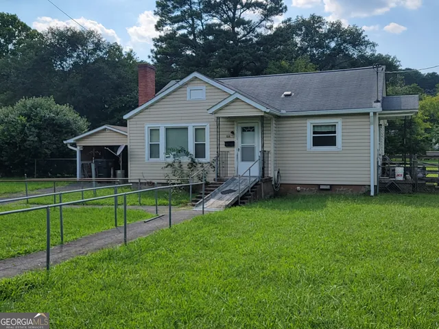 a view of a house with a yard and a garden