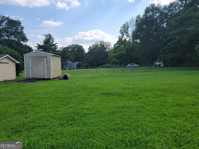 a view of a backyard with large trees