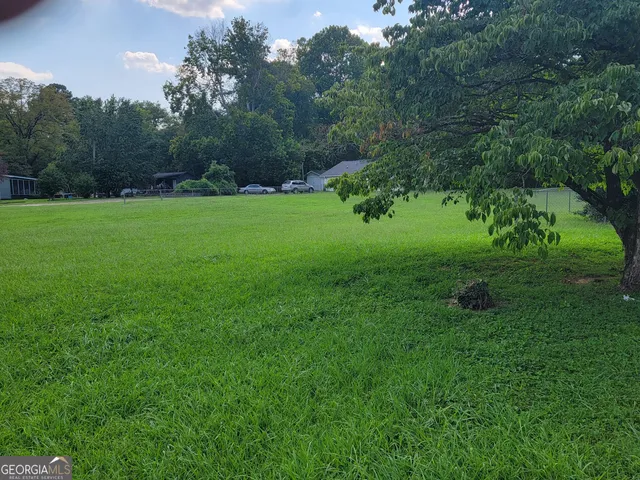 a view of green field with trees