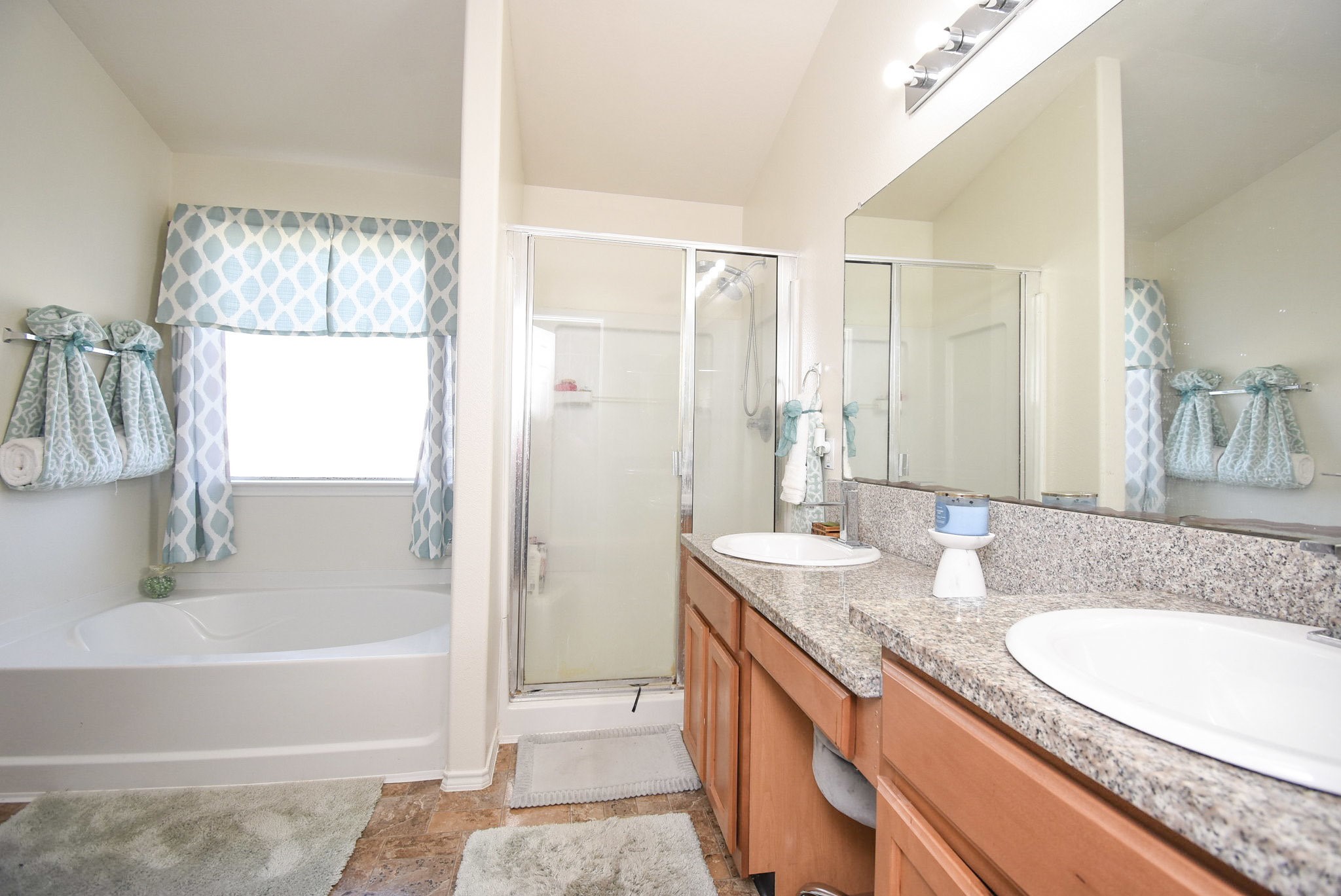 8502 Parapet Place Rosharon, TX 77583 - Photo 21 of 34 Beautifully open and roomy, your primary ensuite bath features great counter space, compact shower stall and exquisite garden tub under a privacy window, left.