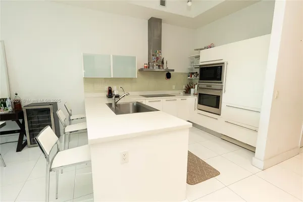 a kitchen with a sink appliances and cabinets