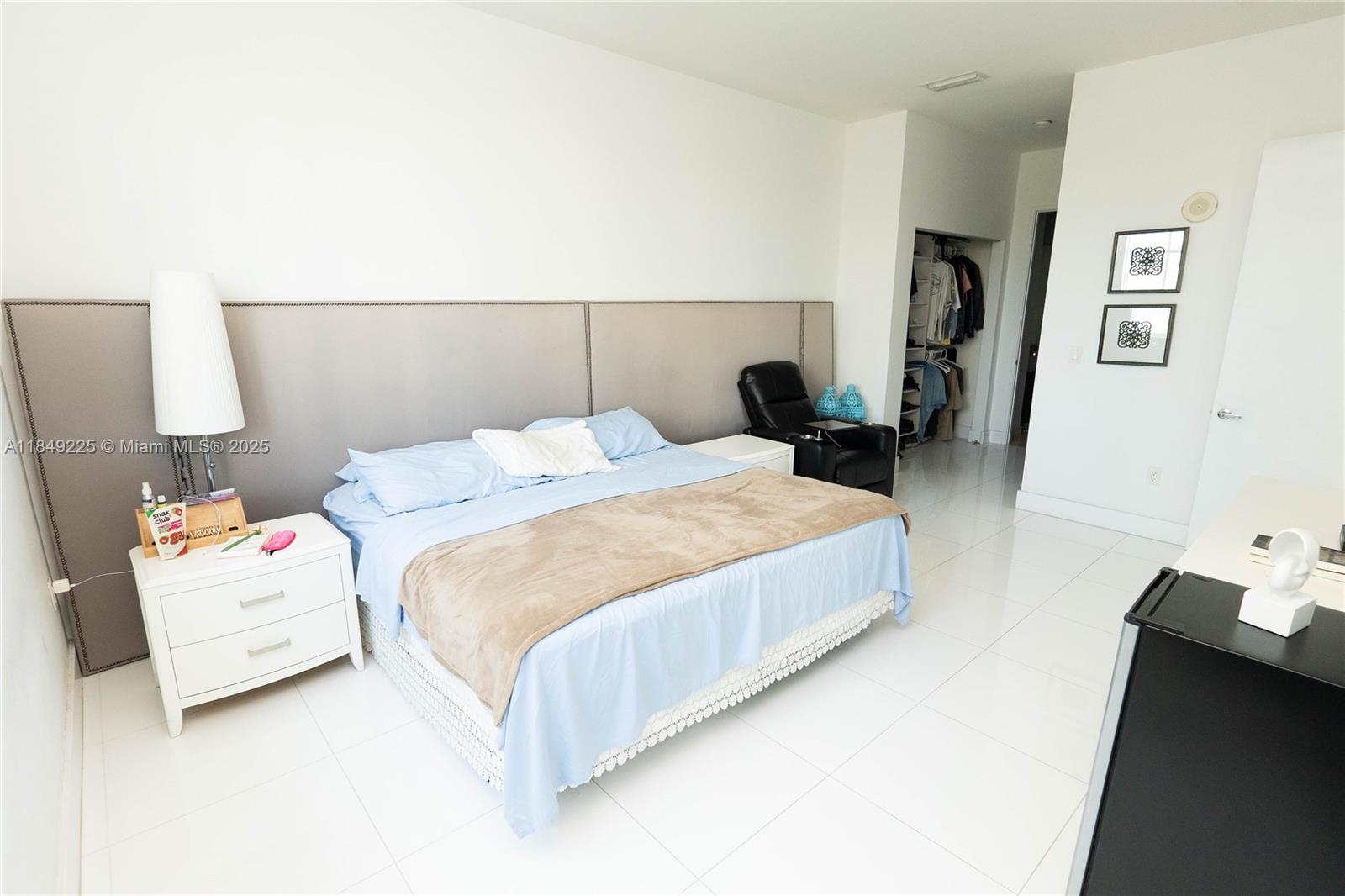 150 Sunny Isles Boulevard, Unit 1TH403 Sunny Isles Beach, FL 33160 - Photo 15 of 34 a bedroom with a bed and a potted plant