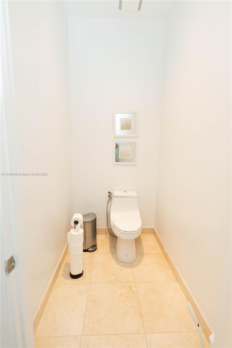 150 Sunny Isles Boulevard, Unit 1TH403 Sunny Isles Beach, FL 33160 - Photo 16 of 34 a bathroom with a toilet and a sink