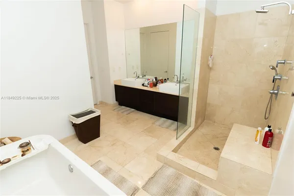 a bathroom with a tub sink and mirror