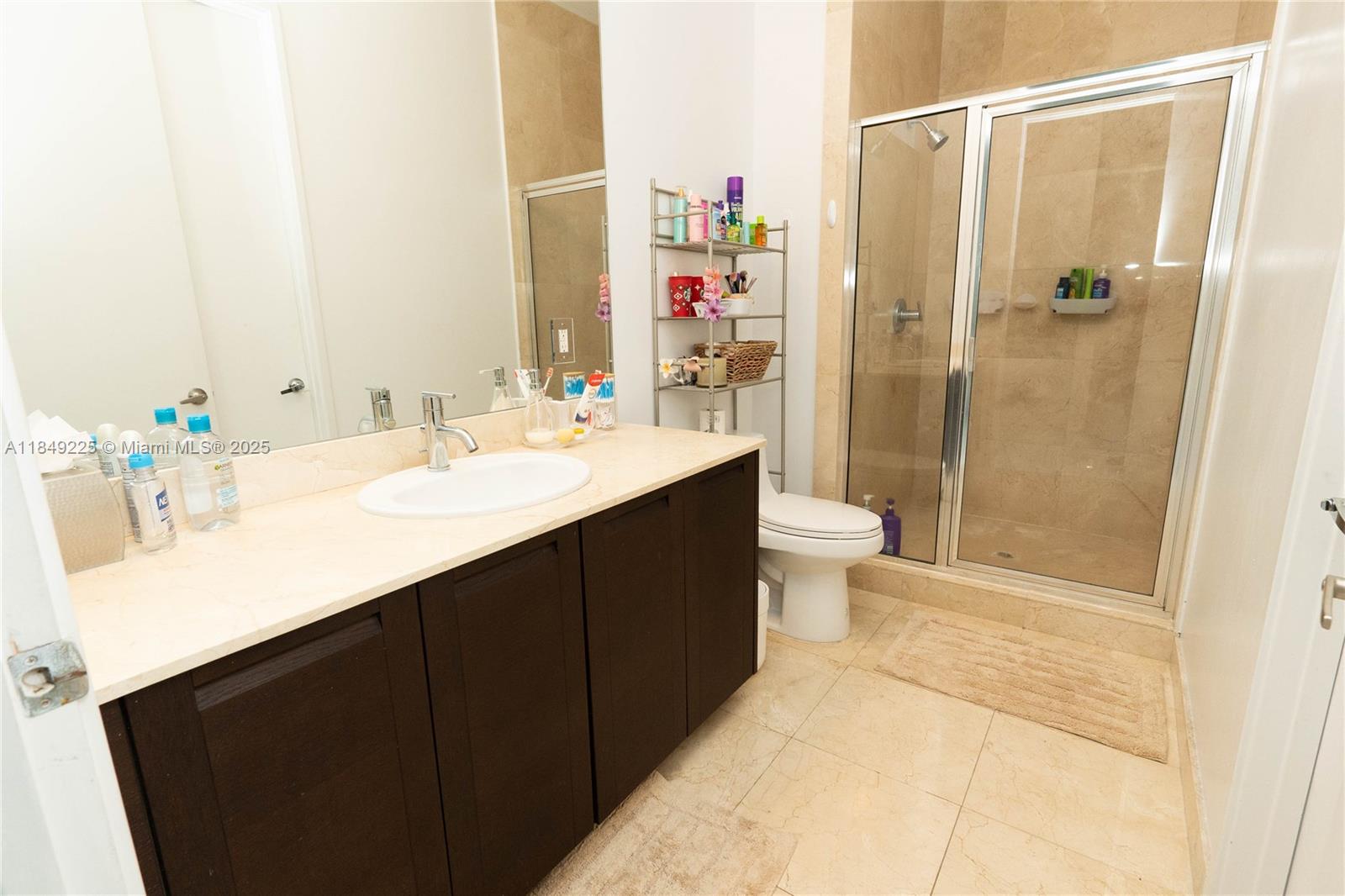 150 Sunny Isles Boulevard, Unit 1TH403 Sunny Isles Beach, FL 33160 - Photo 23 of 34 a bathroom with a sink vanity mirror and toilet
