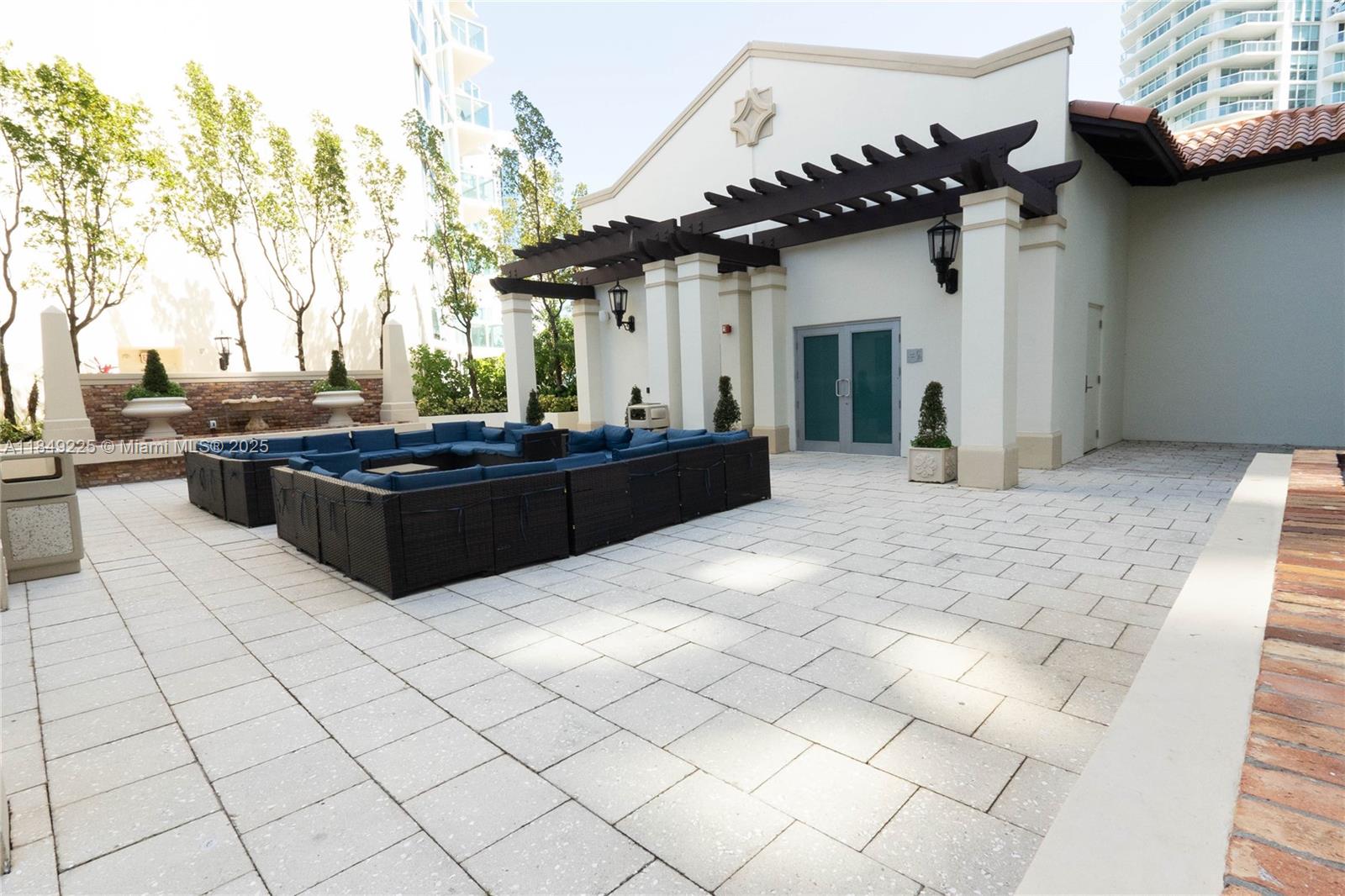 150 Sunny Isles Boulevard, Unit 1TH403 Sunny Isles Beach, FL 33160 - Photo 24 of 34 a view of a house with backyard