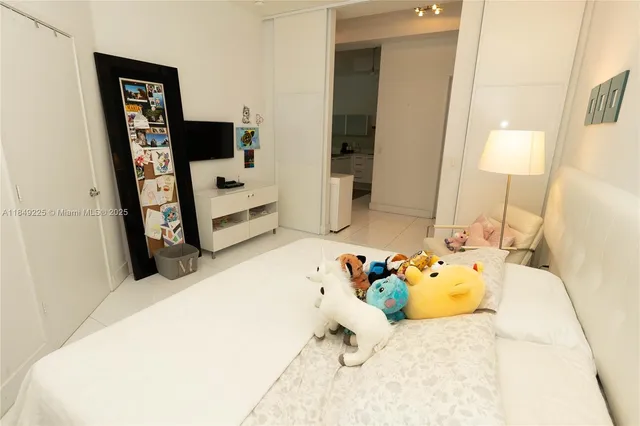 a bed room with a bed and a television