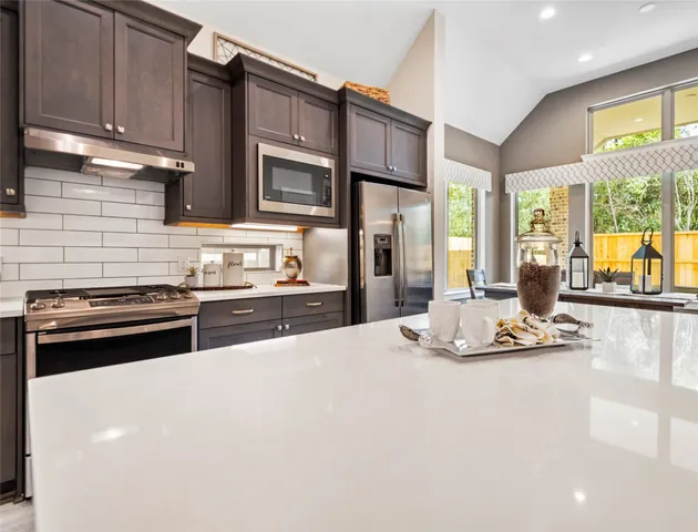 a kitchen with stainless steel appliances a sink and cabinets