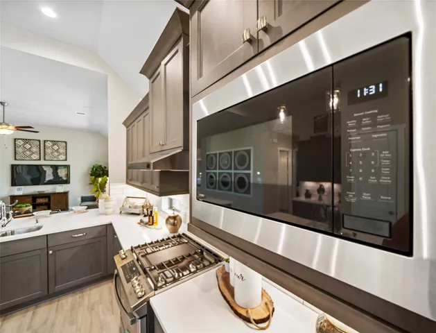 a kitchen with stainless steel appliances granite countertop a sink and cabinets