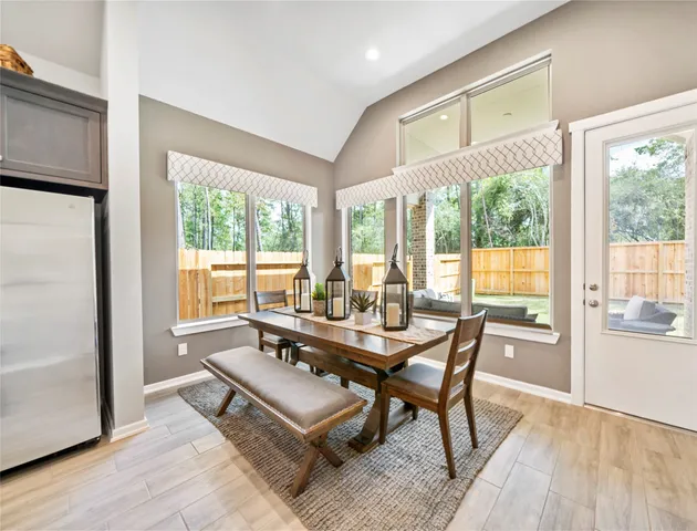 a dining room with furniture window and wooden floor