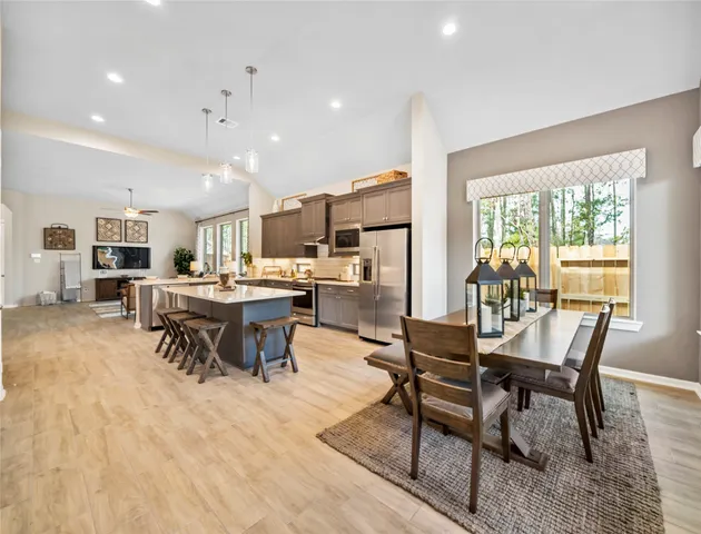 a view of a dining room with furniture and a floor to ceiling window