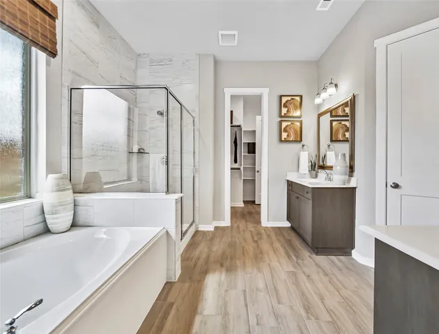 a spacious bathroom with a tub shower and sink