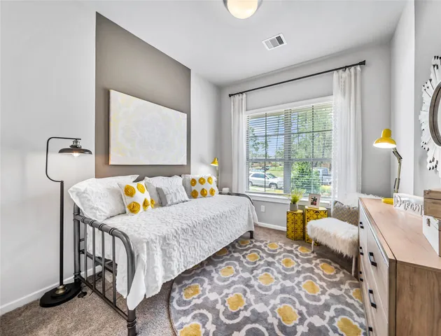 a bedroom with a bed and window