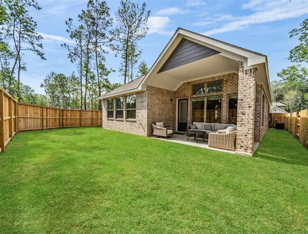 a view of a house with backyard porch and sitting area