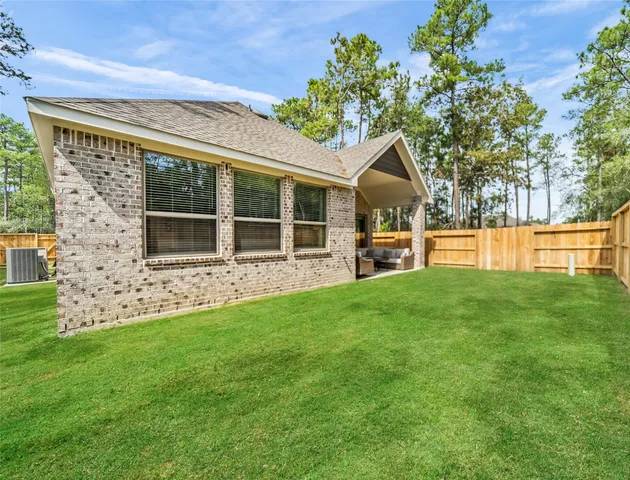 a backyard of a house with lots of green space and garden