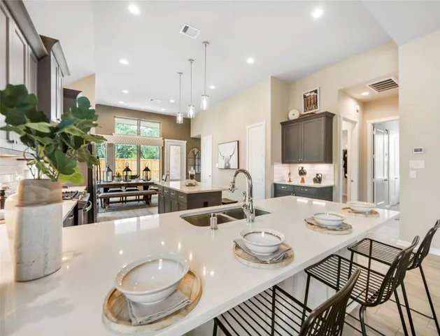 a dining room with furniture a mirror and kitchen view