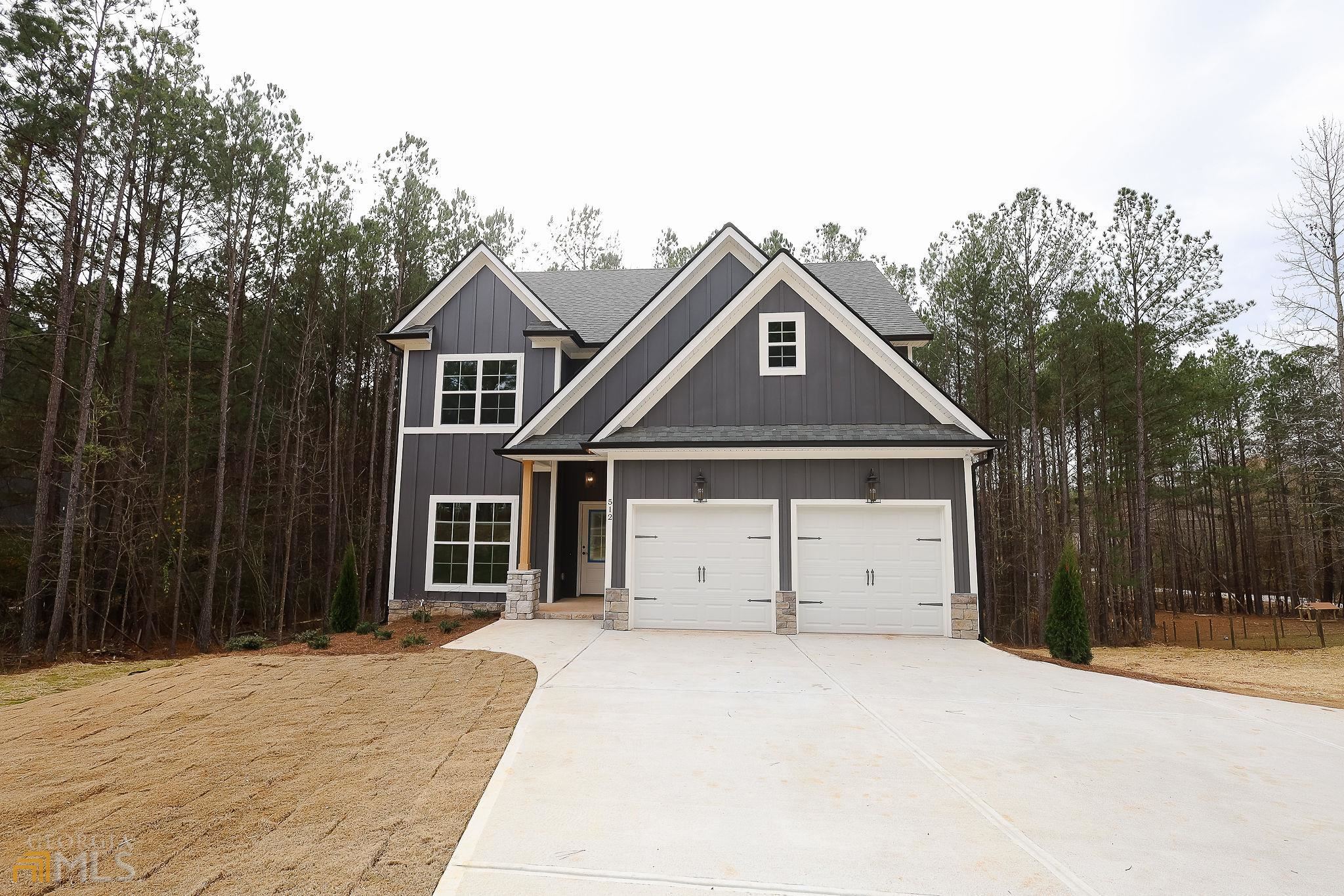 512 McKoy Road Newnan, GA 30263 - Photo 1 of 1 a front view of a house with a yard and garage