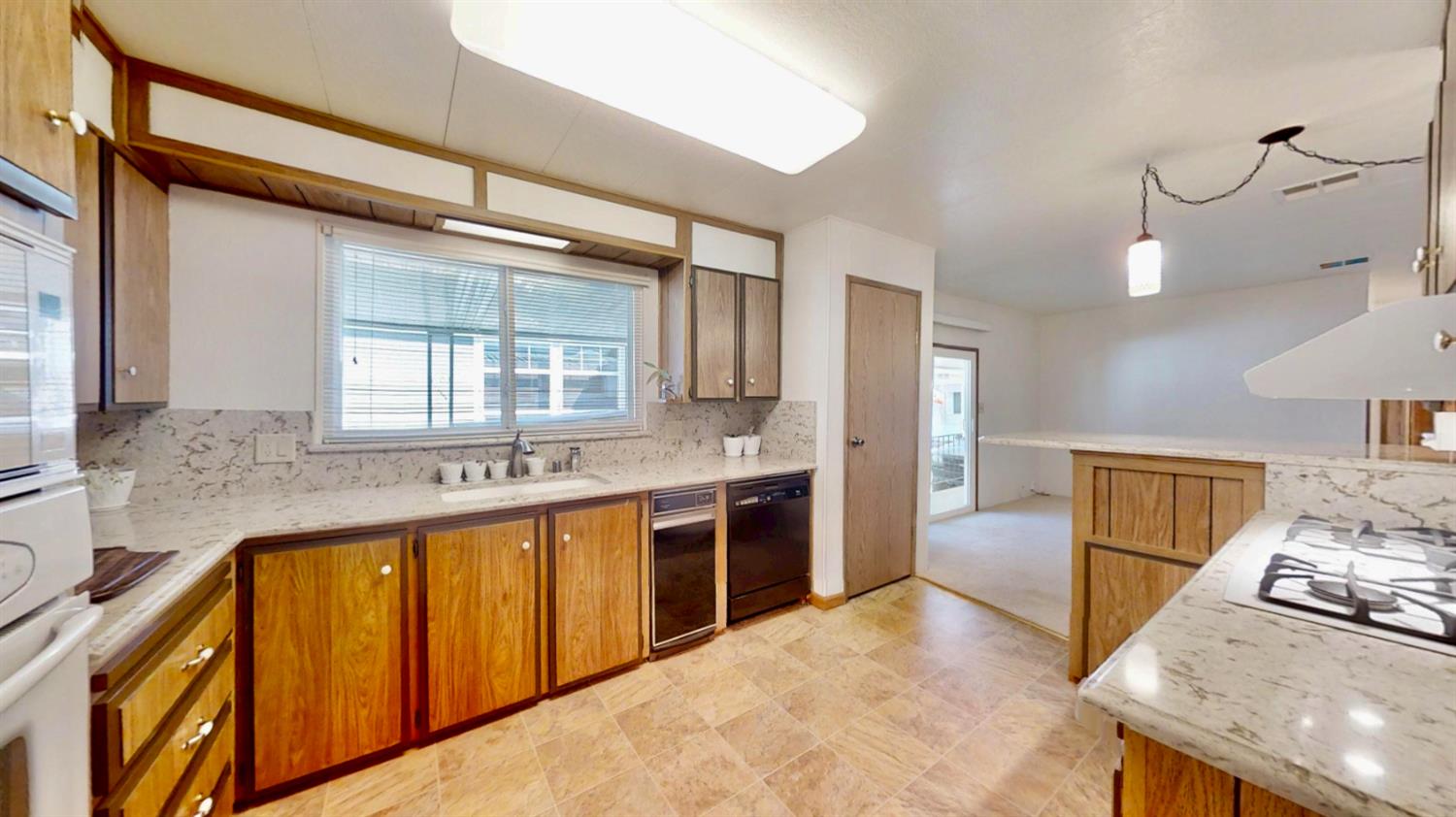 6203 Freedom Lane Citrus Heights, CA 95621 - Photo 6 of 51 Spacious accessible kitchen with granite counters! Comes with a standing freezer in the pantry/laundry room.