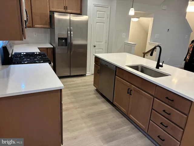 a kitchen with cabinets and stainless steel appliances