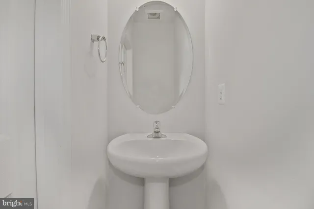 a bathroom with a sink and mirror