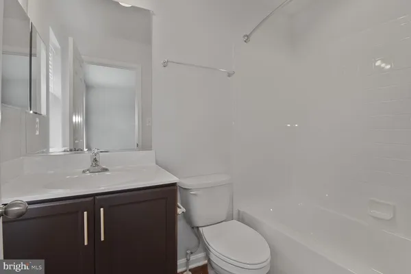 a bathroom with a sink toilet vanity and shower